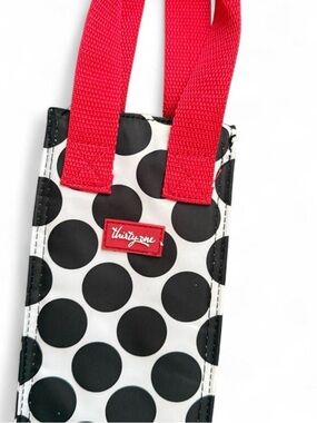 THIRTY-ONE brand black and white polka dot bottle carrier with red accents.